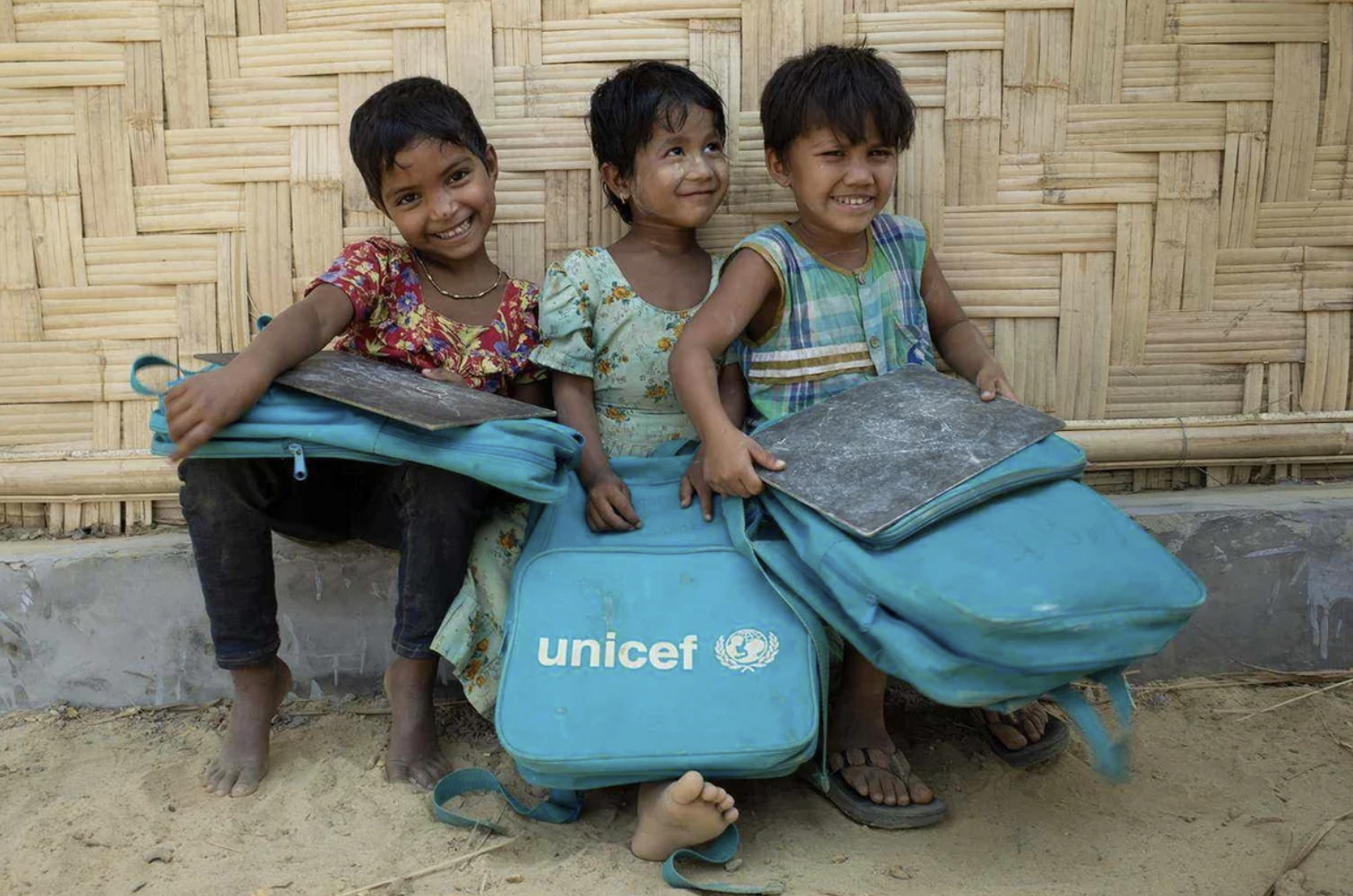 عدد من أطفال الروهينجا يحملون حقائب دراسية عليها شعار منظمة الأمم المتحدة للطفولة (صورة: UNICEF)